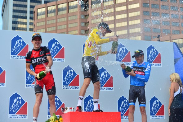 Mathias Frank, Tejay van Garderen and Tom Danielson their final placings celebrate by soaking each other, the crowd and the podium girls after their presentation. 