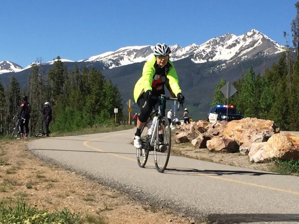 A rider rides the bike path over the Lake Dillon Dam.